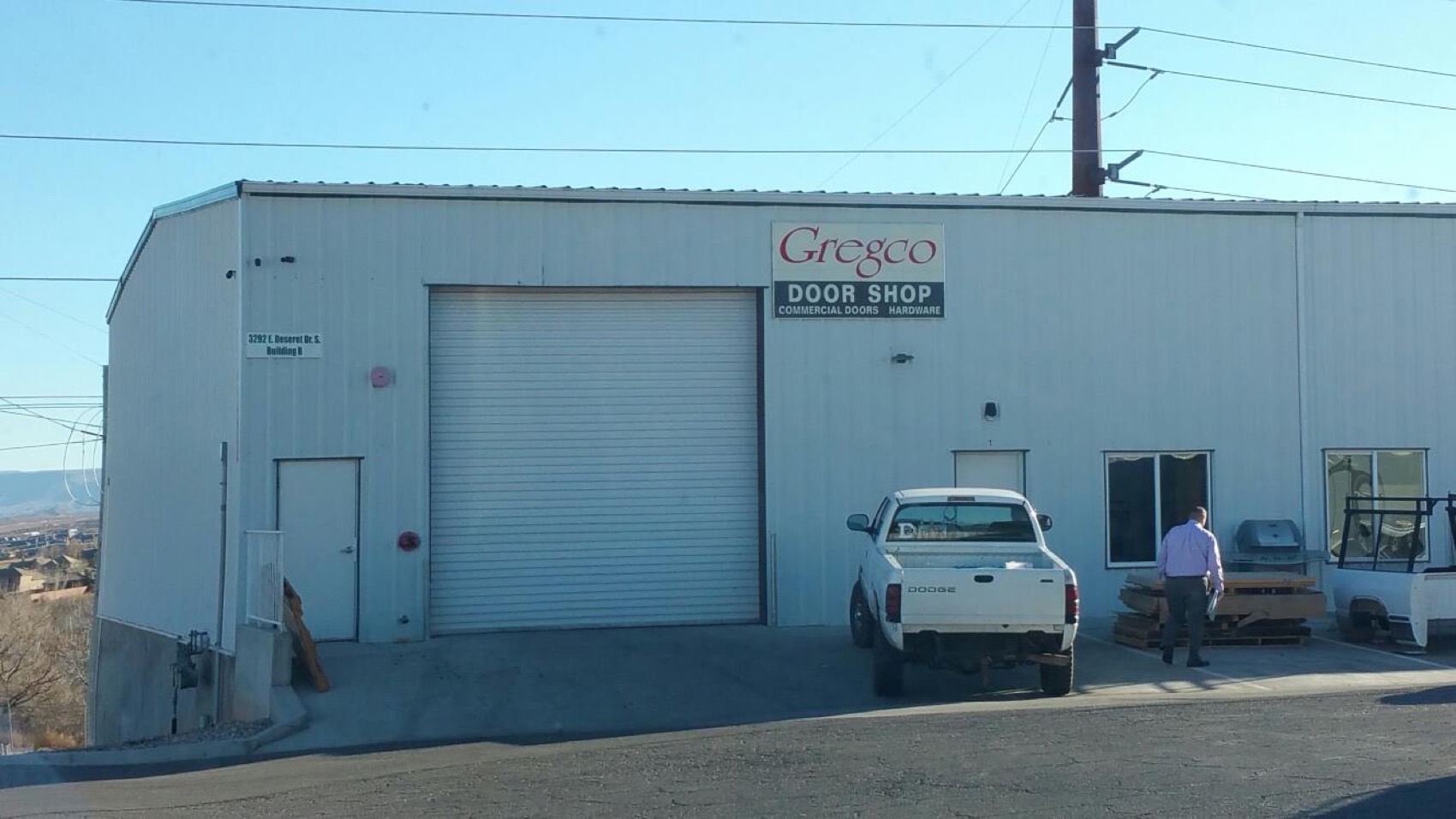 Gregco's commercial door shop in St. George, Utah — steel warehouse with roll-up door and work truck
